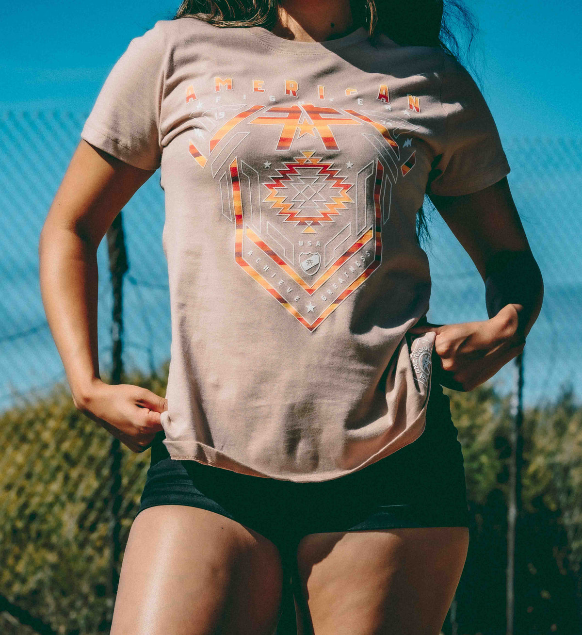 Person wearing a t-shirt with a geometric design outdoors