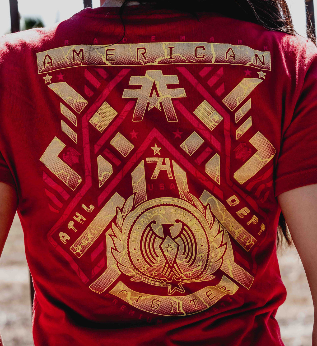 Red shirt with gold emblem and text on the back