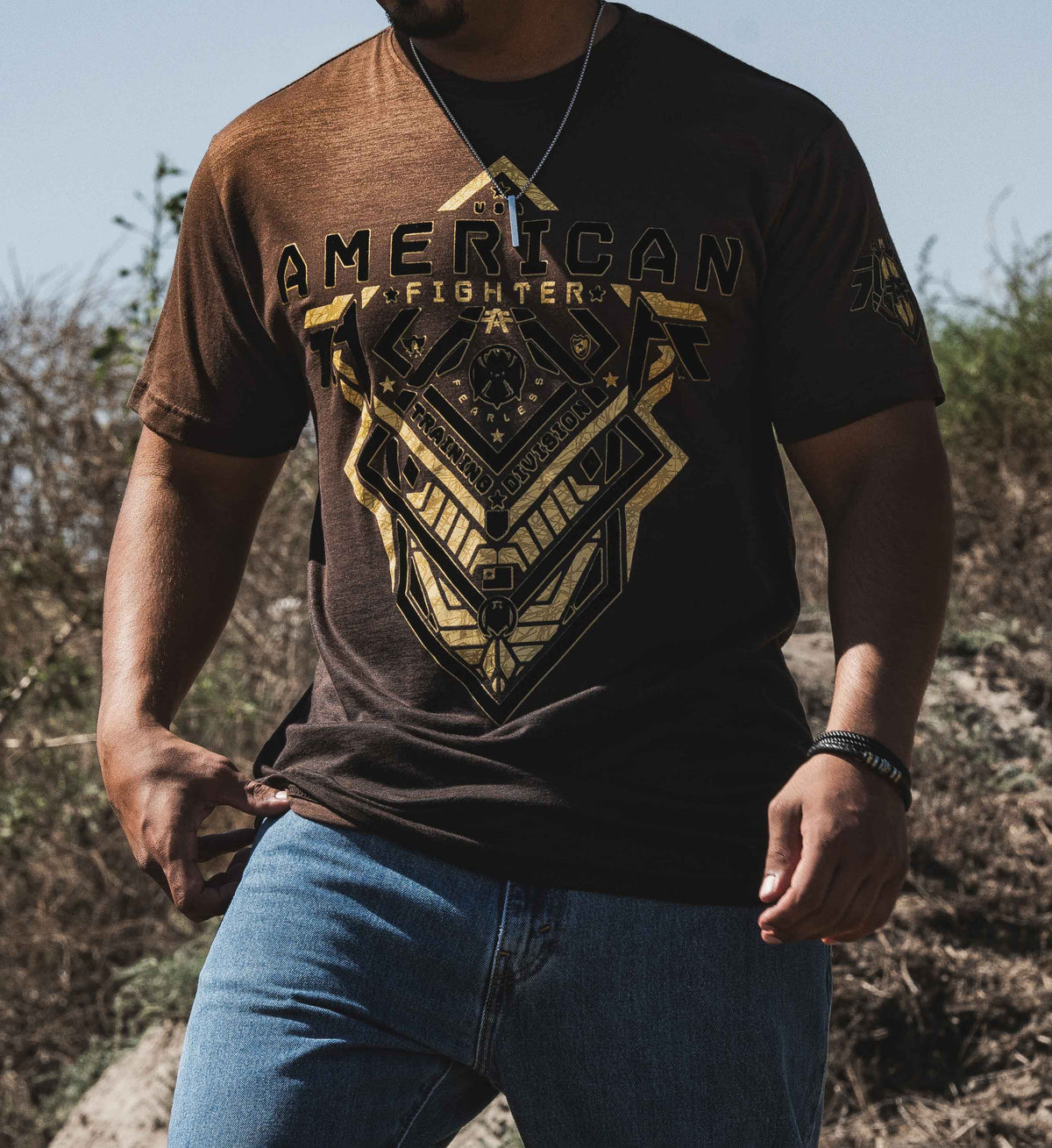 Person wearing a 'American Fighter' t-shirt outdoors