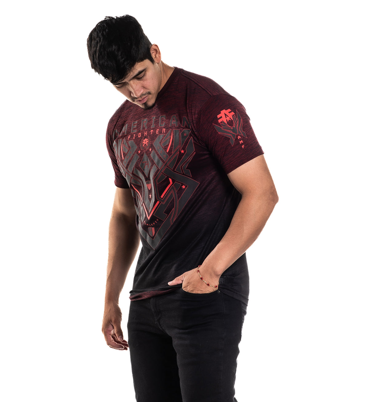 Man wearing a dark red t-shirt with graphic designs on a white background