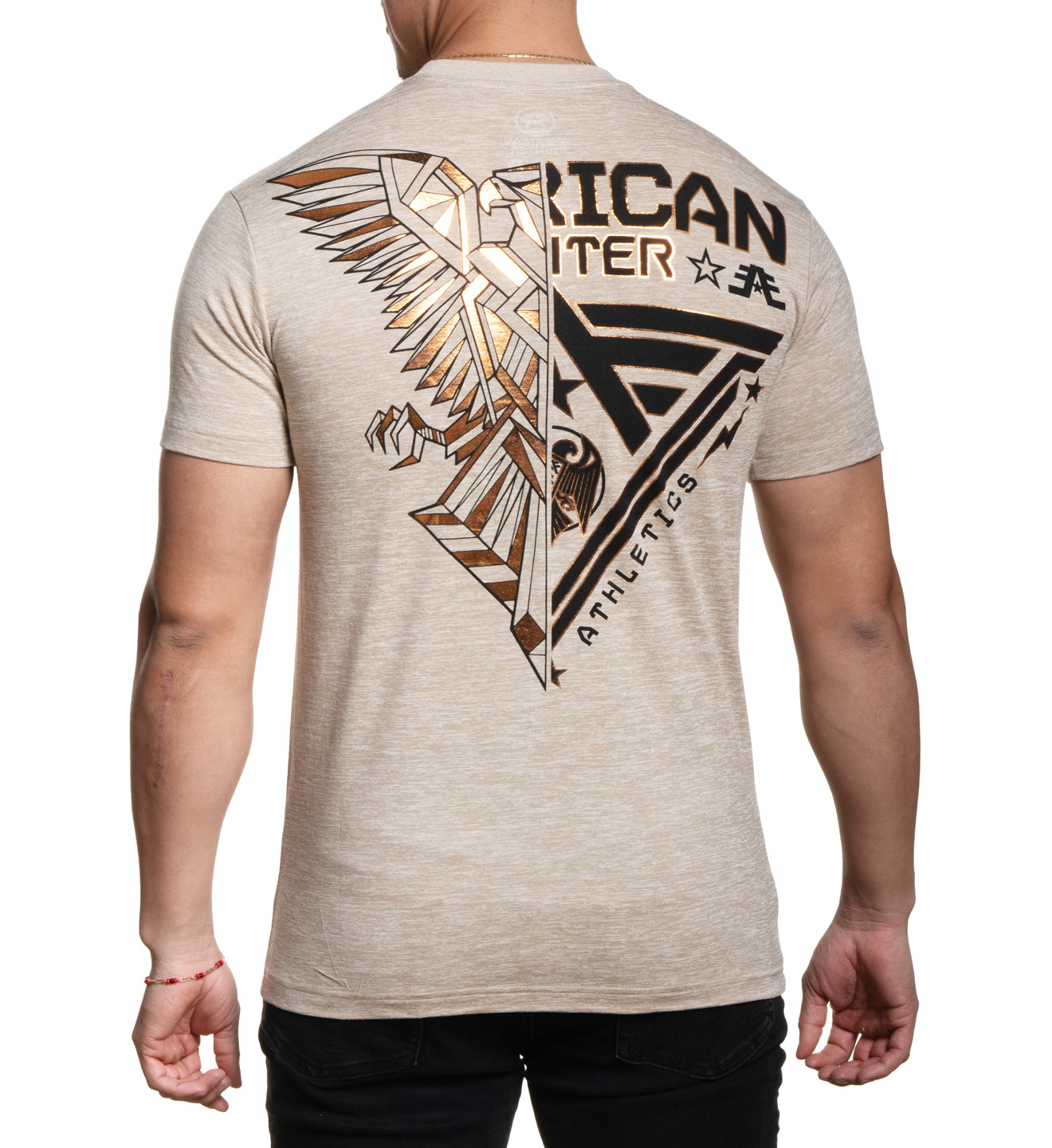 A male model wearing a beige t-shirt with 'AMERICAN' and an eagle graphic printed on the front.