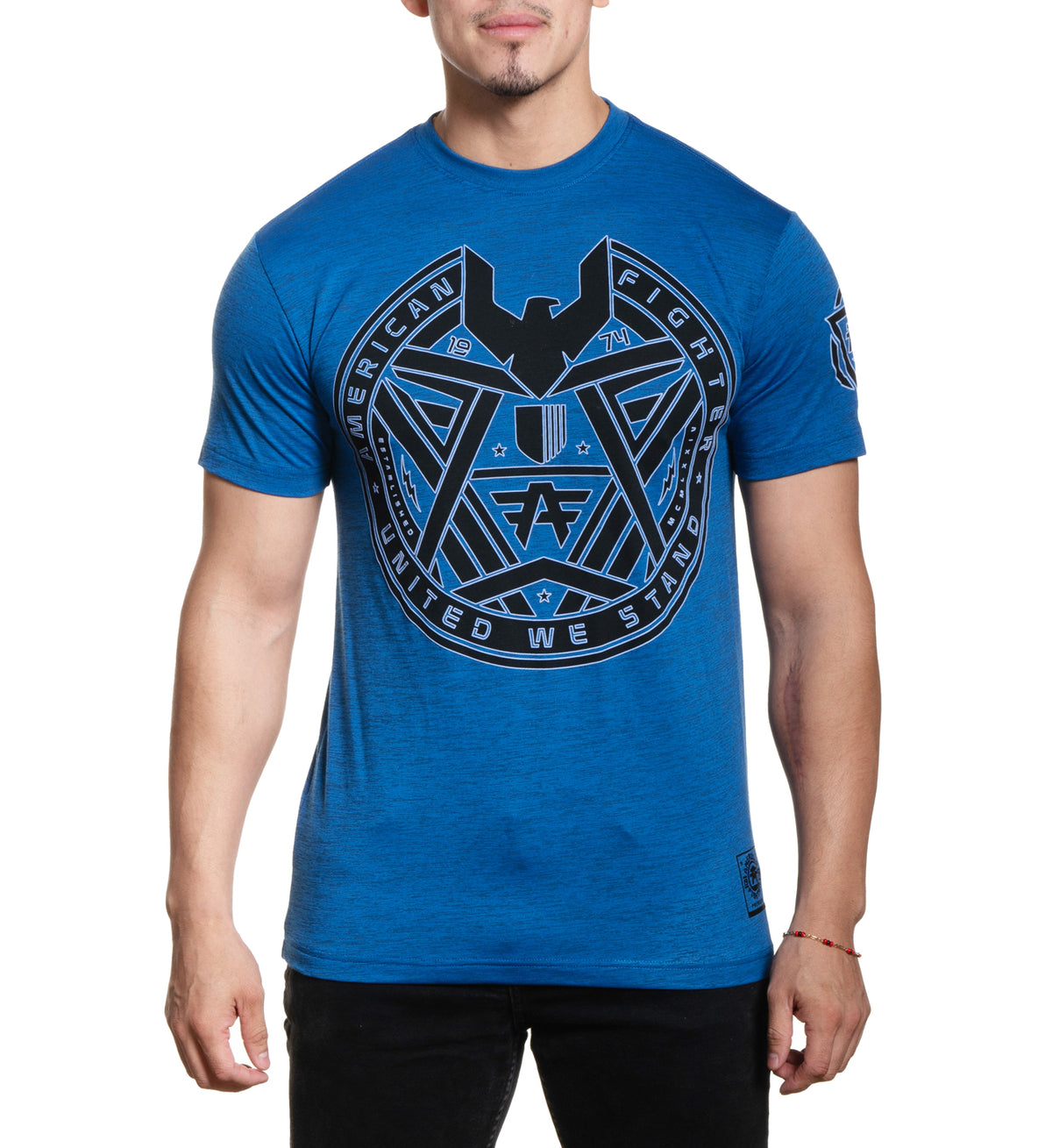 A male model wearing a blue short-sleeved t-shirt with a graphic print on the front.