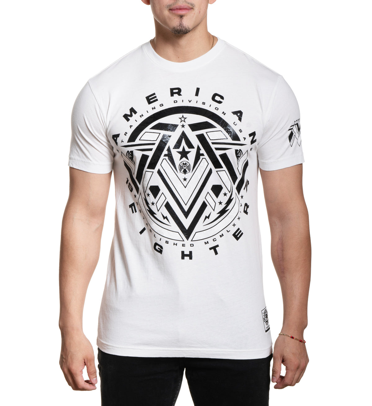 A male model wearing a white short-sleeved t-shirt with 'AMERICAN FIGHTER' text and logo graphic on the front.