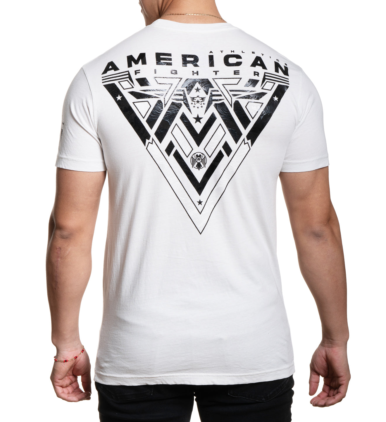 A male model wearing a white short-sleeved t-shirt with 'AMERICAN FIGHTER' text and logo graphic on the front.