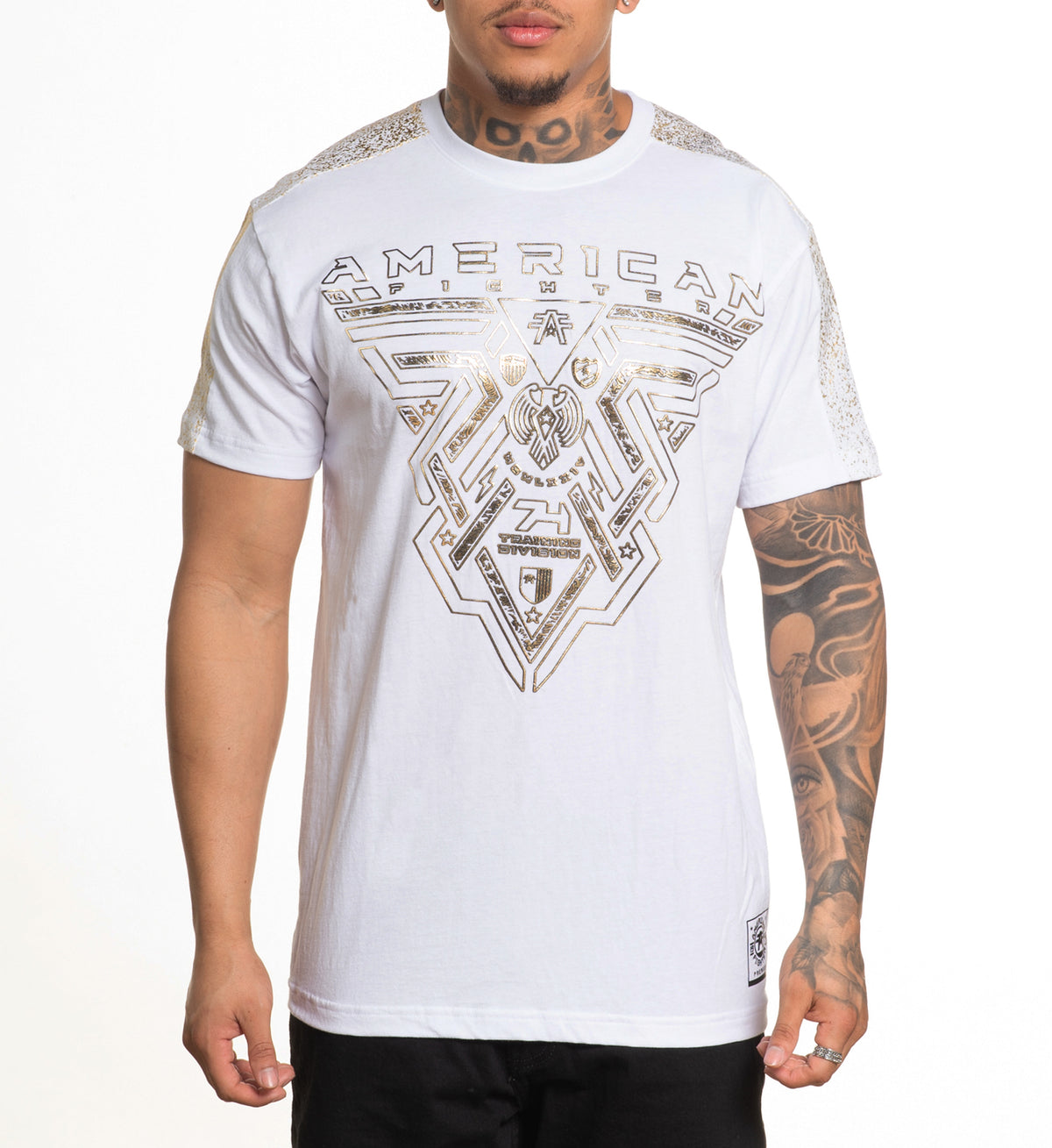 A male model wearing a white short-sleeved t-shirt with gold foil text and geometric patterns on the shoulder panels.