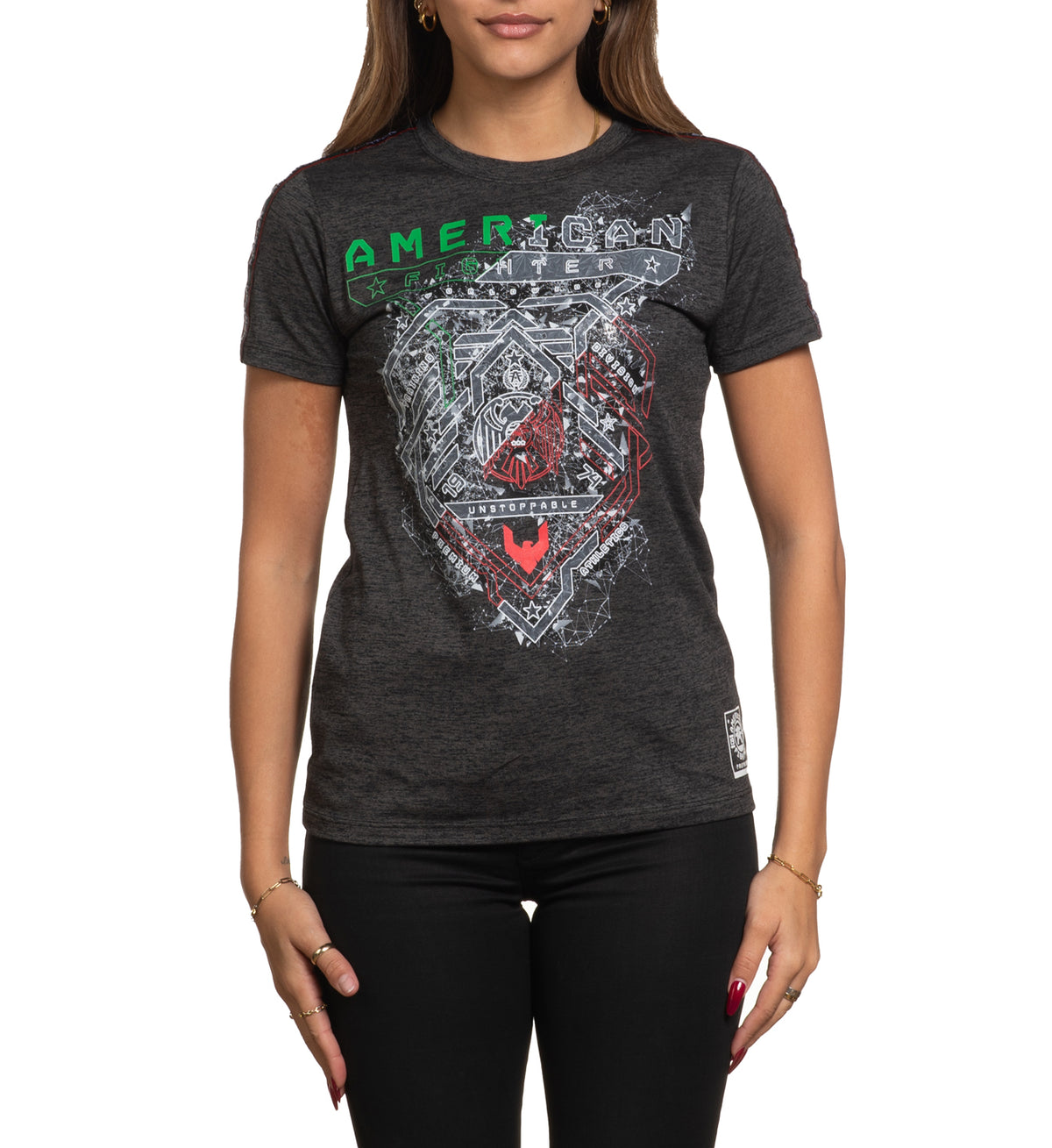 A woman wearing a black short sleeve crew neck t-shirt with a geometric and text design in the center.