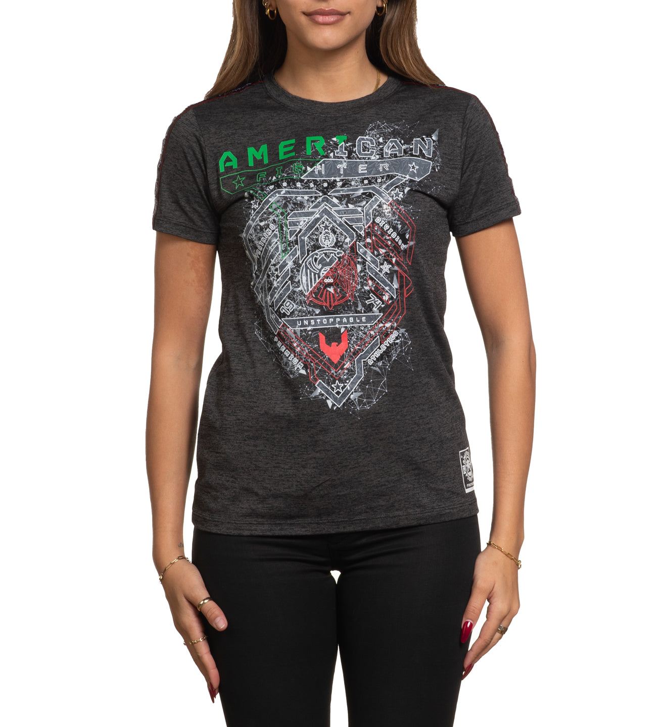 A woman wearing a black short sleeve crew neck t-shirt with a geometric and text design in the center.